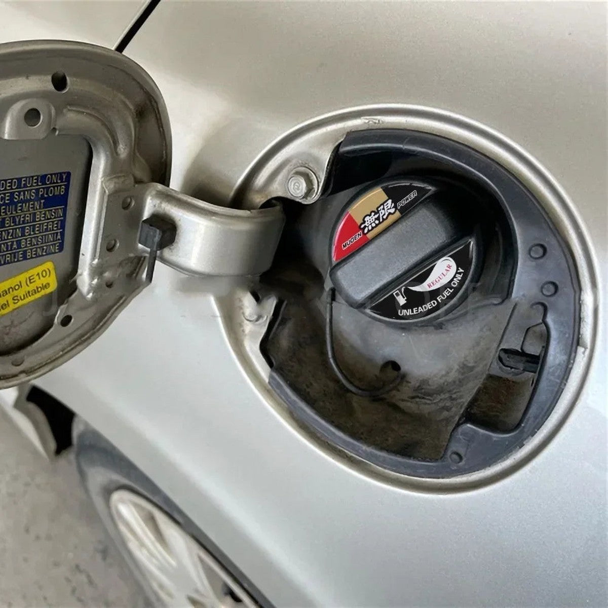 Mugen-style fuel cap decal installed on a Honda fuel cap