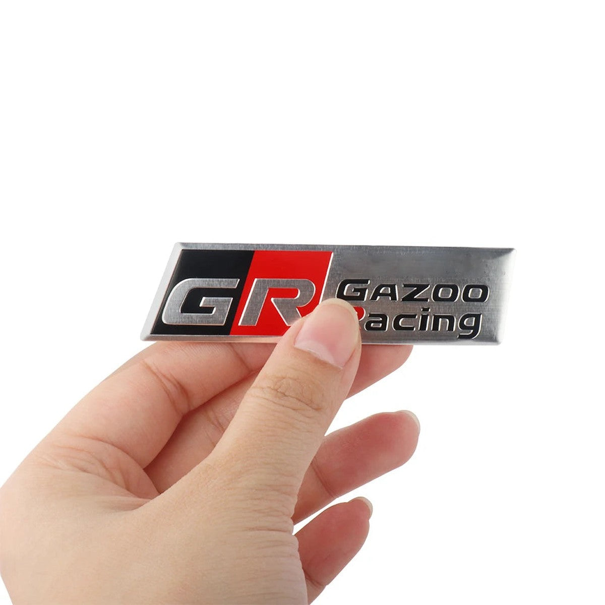 GR Gazoo Racing-style long aluminum badge held in hand