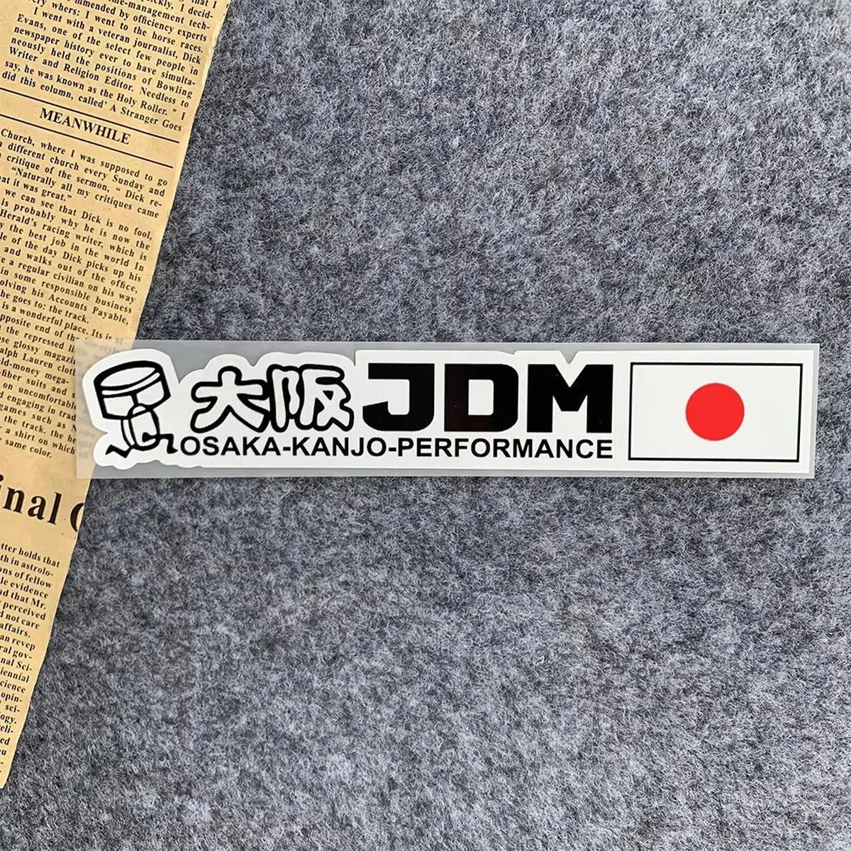 Osaka JDM sticker with Japanese flag on a gray surface