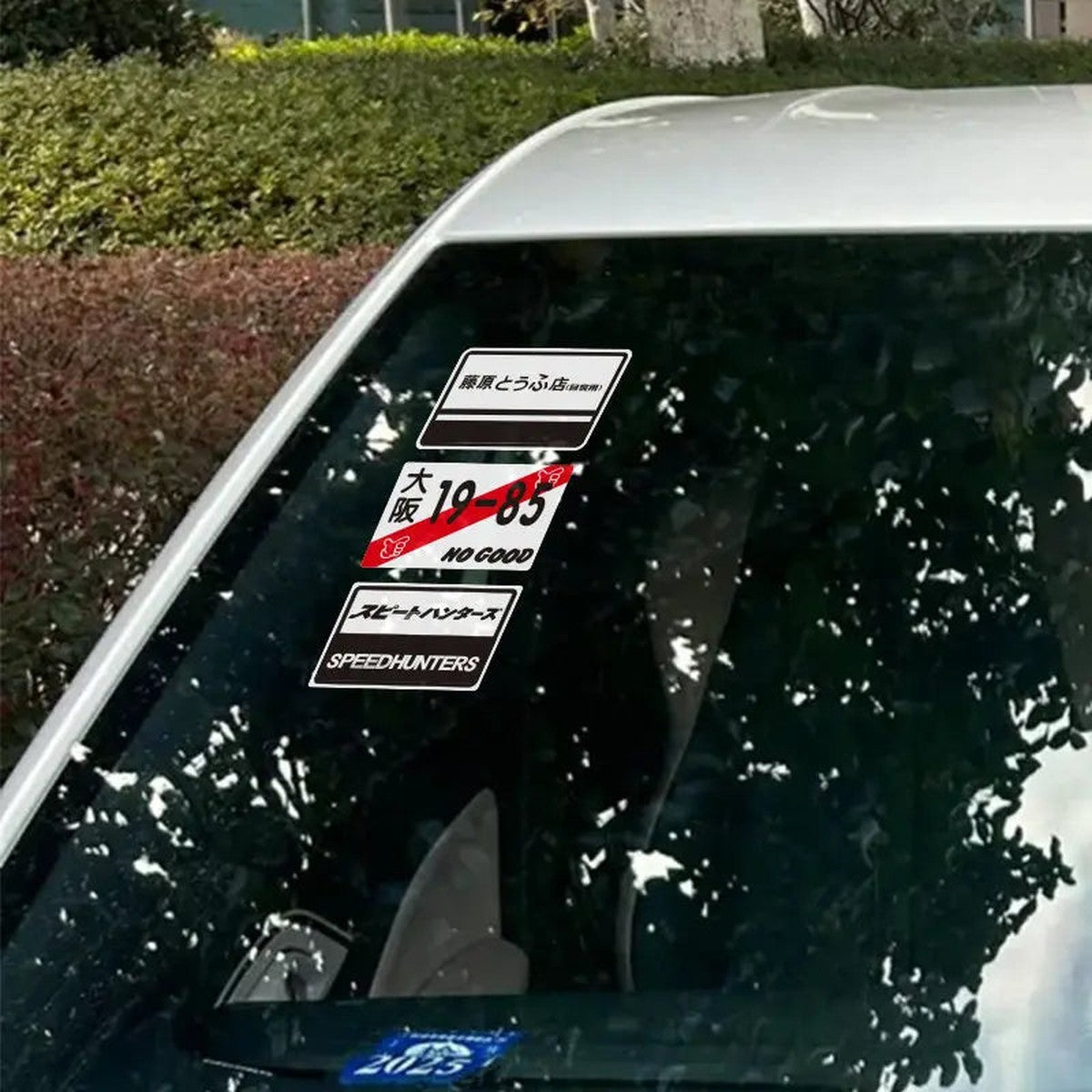 Static cling decals applied to a car windshield corner