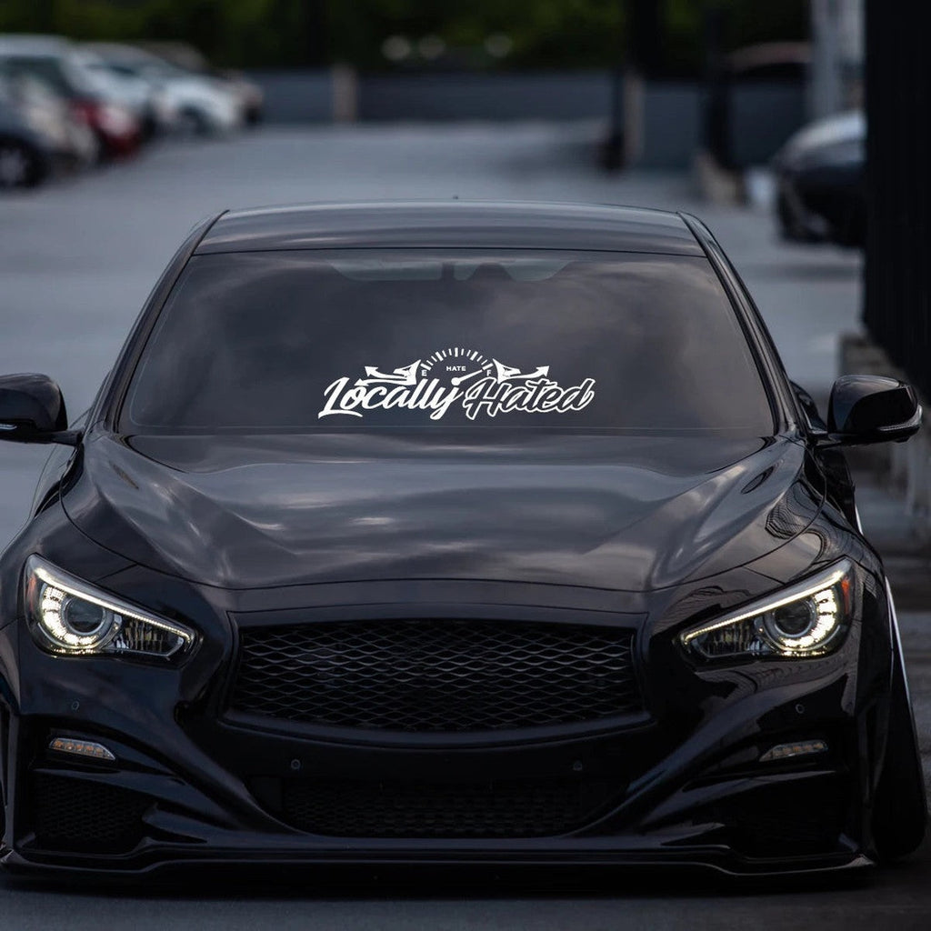 Locally Hated windshield banner on a black Infiniti sedan