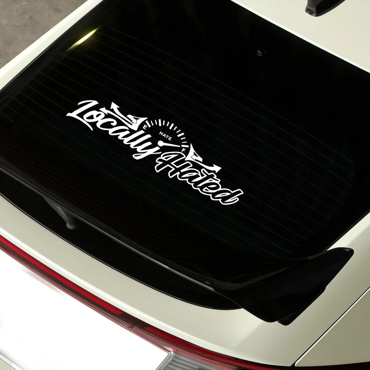 White Locally Hated decal on a tinted rear window