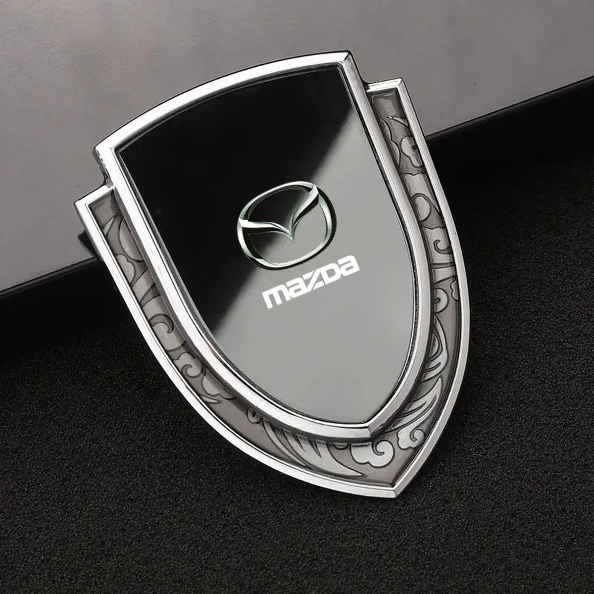 Silver-frame black Mazda-style shield emblem, style A-1