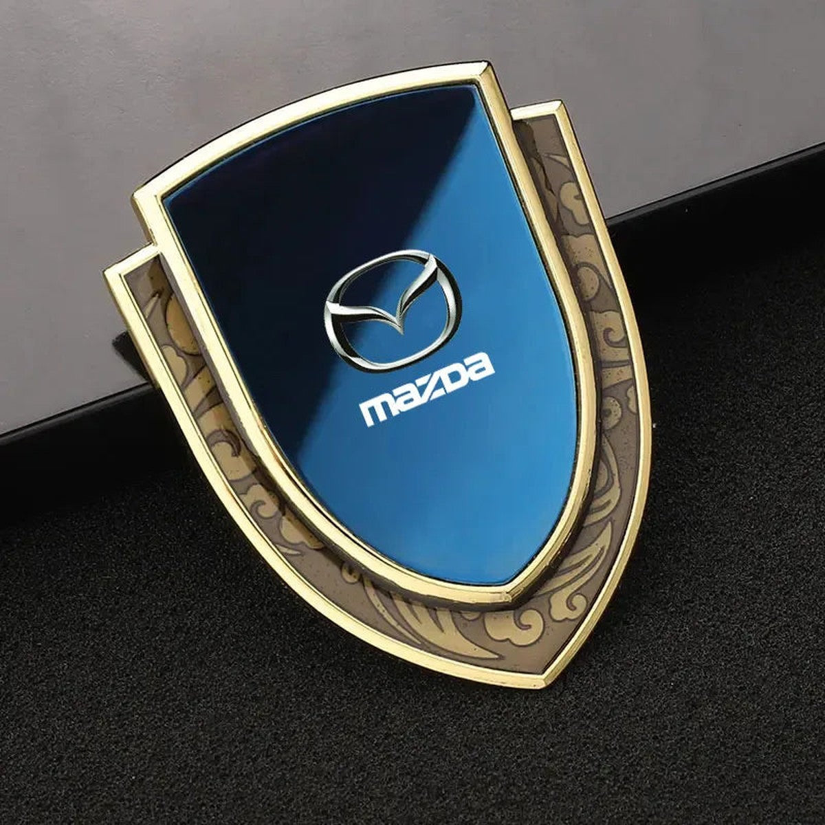 Gold-frame blue Mazda-style shield emblem, style B-2