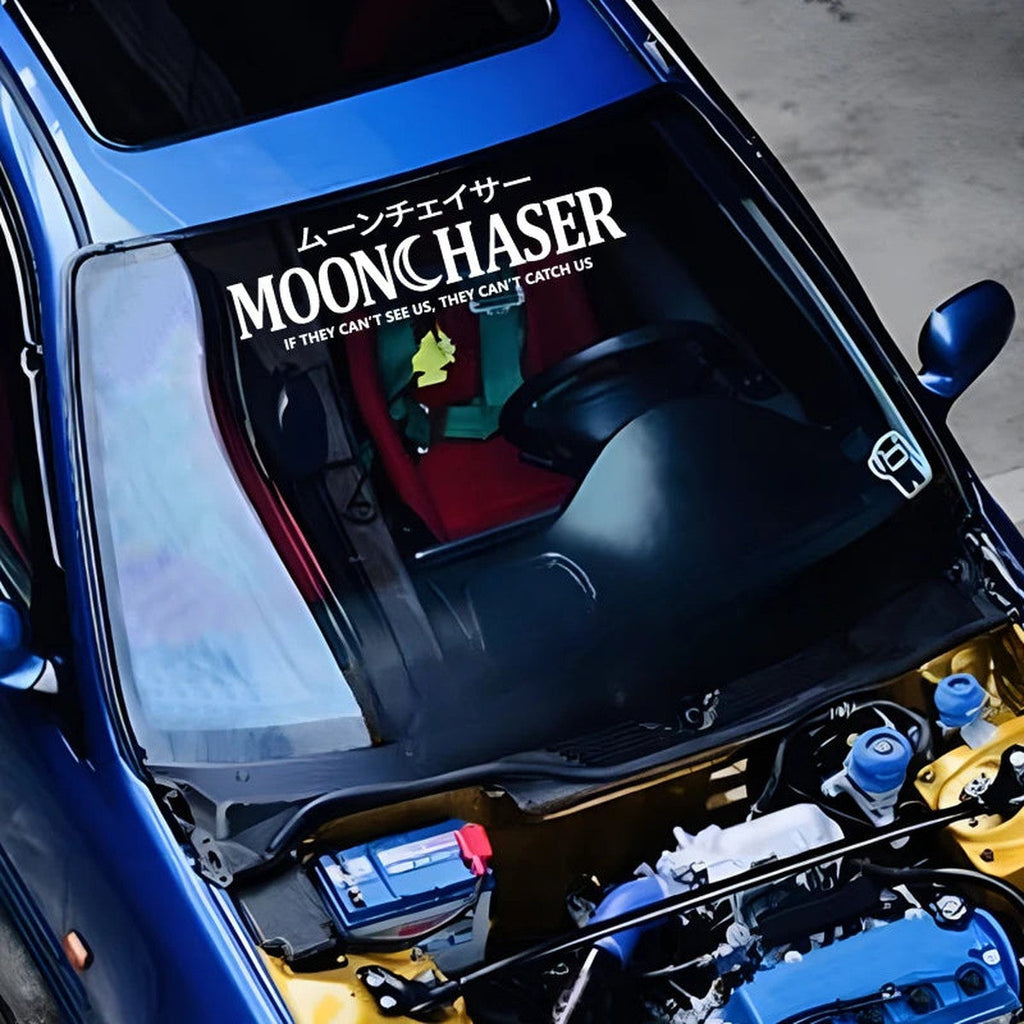 White Moonchaser windshield banner on a blue car with the hood open