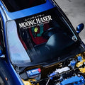 White Moonchaser windshield banner on a blue car with the hood open