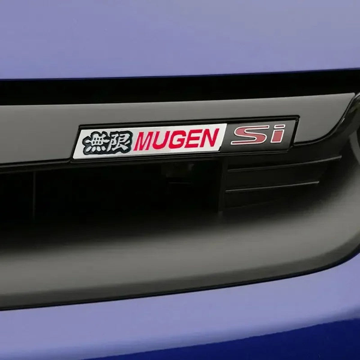 Mugen-style aluminum badge applied to a Honda Civic grille