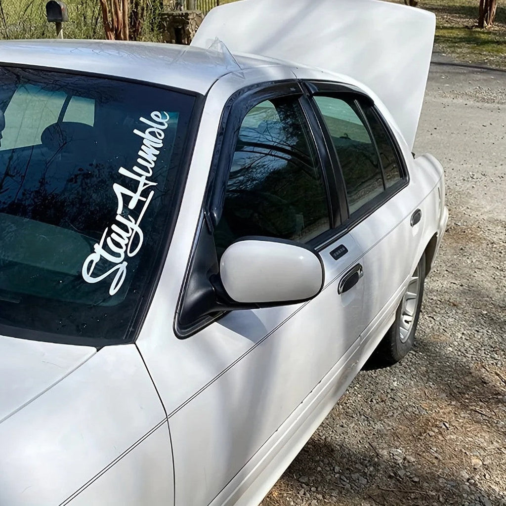 Stay Humble vertical windshield decal on a white sedan