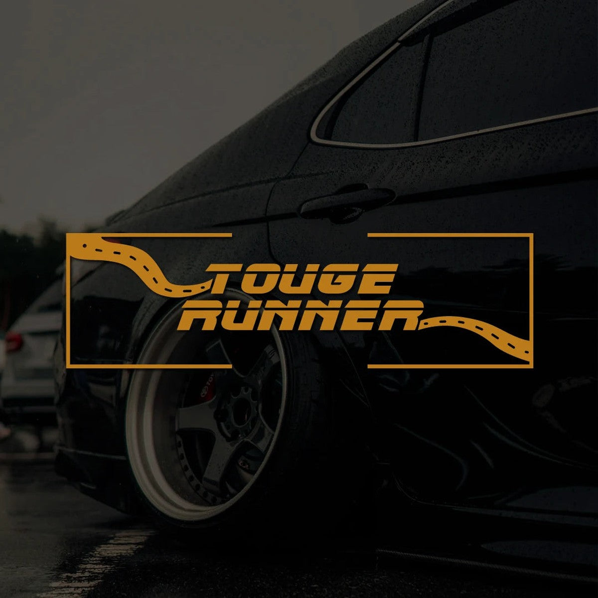 Gold Touge Runner JDM sticker over a dark car at night